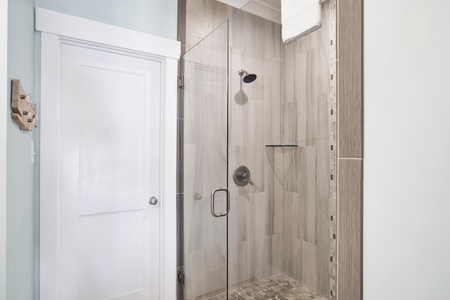 It features a walk-in, tile shower