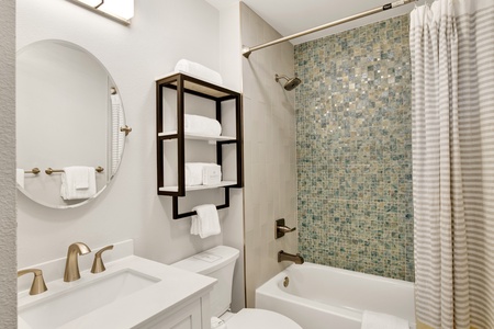 Shared bathroom features a tub/shower combo, accessible from the hallway