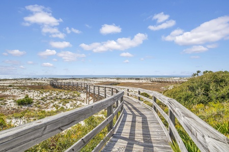 Boardwalk to the beach located near the pool