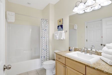 Located upstairs, full bath with shower tub combo shared between bedroom 3 and 4