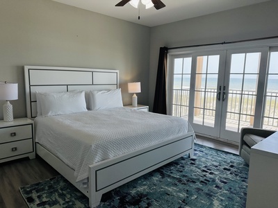 Bedroom 1 is on the 2nd floor with a king bed, TV, Gulf views, balcony access and a private bathroom