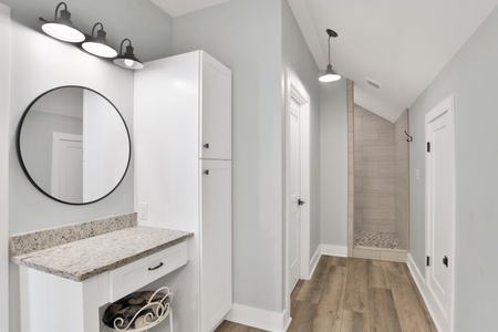Makeup vanity and walk-in tile shower