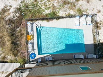 The pool area is secured with a fence