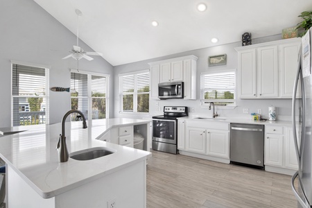 Large kitchen with quartz countertops and stainless appliances