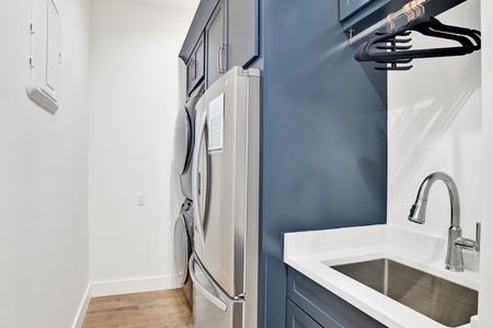 The 1st floor laundry room has a full size washer/dryer, 2nd fridge and sink