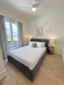 Bedroom 2 has balcony access and a private bathroom