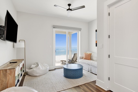 2nd floor living area with a TV, Gulf views and balcony access