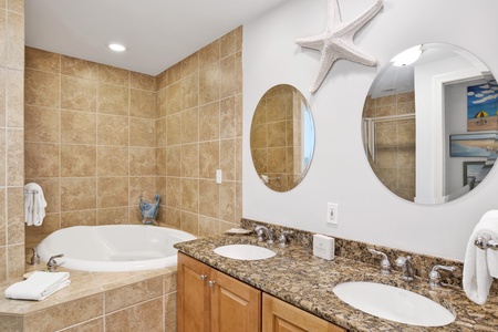 Private bathroom in Bedroom 2 with a walk-in shower, double vanity, and a jacuzzi tub