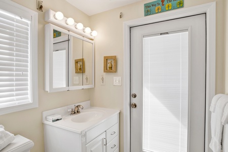 The private bath in bedroom 3 has deck access