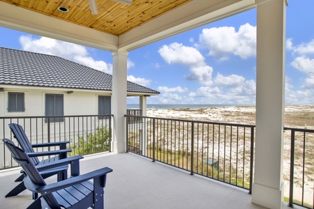 The covered balcony offers seating with views of the Gulf