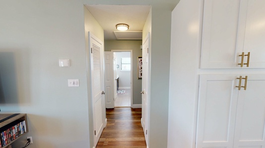 Hallway leading from the kitchen/living room into bedrooms 2,3, & hall bath.