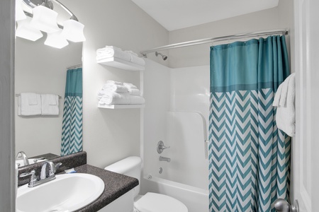 Shared hall bathroom with a tub/shower combo