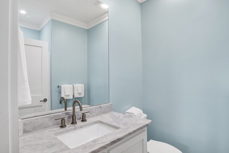 The private bathroom features a single vanity and walk-in shower