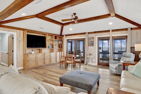 The living room offers a TV, table for 4 and access to the screened porch