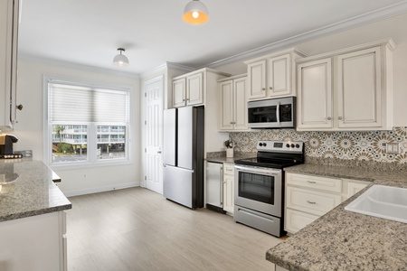 Beautiful updated kitchen with granite, tile backsplash and stainless appliances