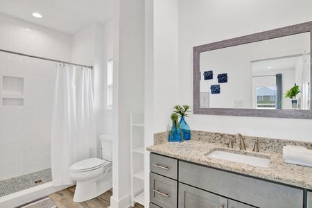 The private bathroom has granite counters