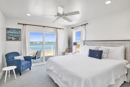 Bedroom 1 comes with a queen bed, Lagoon views and deck access.
