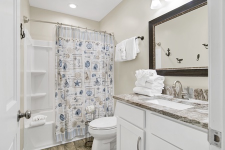 The shared hallway bathroom features a tub/shower combo
