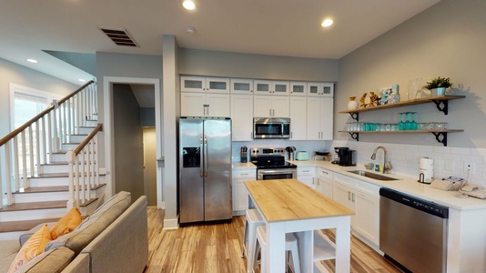 Coastal Kitchen with stainless steel appliances and bar seating