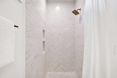 Walk-in tiled shower in in the bath in Bedroom 4