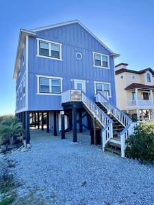 Covered parking for 3 under the home and additional driveway space