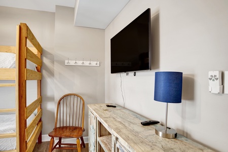 1st floor bunk bedroom has a TV and shares the hallway bathroom