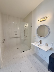 The private bathroom is wheelchair friendly with a roll in shower and roll up counter