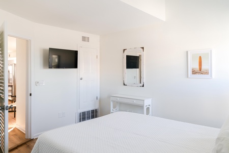 Bedroom #2 has a TV and an entrance into the shared 1st floor bath