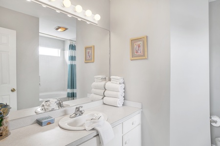 Private master bedroom with a tub/shower combo