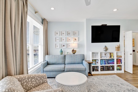 The master bedroom has a TV and sleeps 4 guests with the sleeper sofa