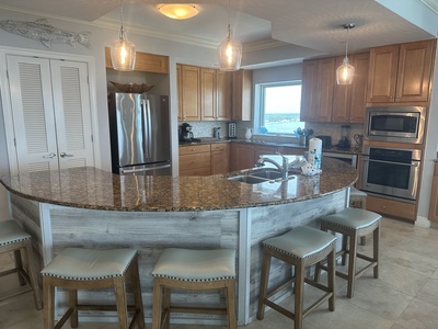 Spacious,modern kitchen with extra seating at the bar