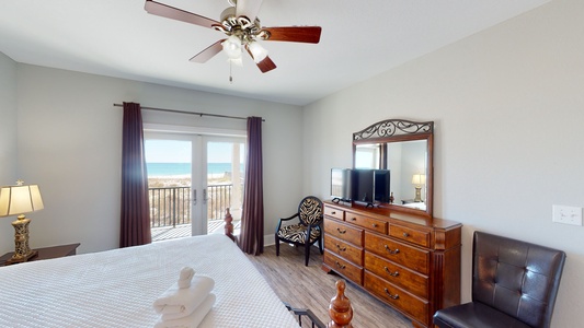 Bedroom 1 features a private bathroom, TV, ceiling fan, Gulf views and balcony access
