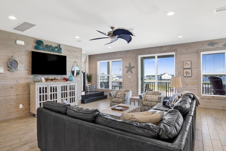 The living room offers a TV and balcony access