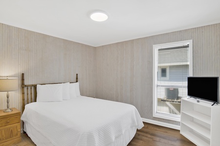 Bedroom 2 offers a Queen bed and TV