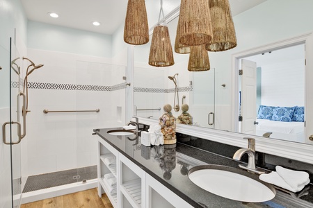 The master bathroom features double vanities and walk-in tile shower