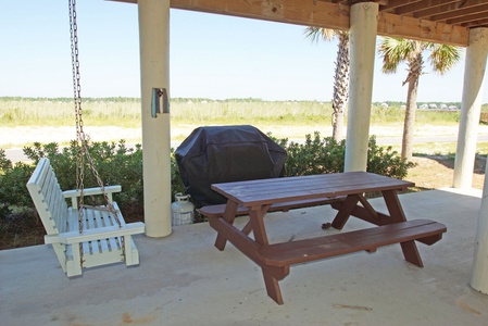 Enjoy sitting on the swing and a meal cooked on the gas grill