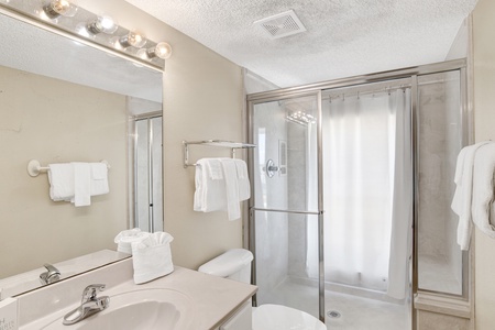 The private bathroom features a walk-in shower