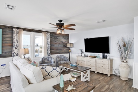 Comfortable living area with a large mounted TV