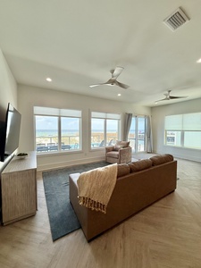 The living room offers balcony access and a TV