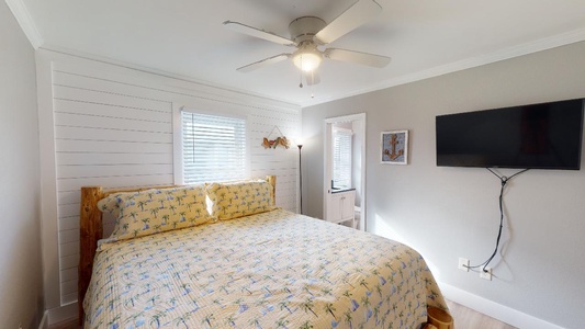 The master bedroom has a king bed, TV and private bathroom