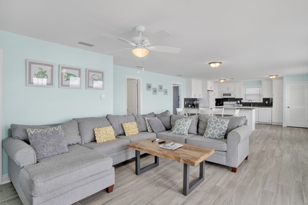 Living area features a large sectional that also doubles as a sofa sleeper for 2, TV, and access to the beach front deck
