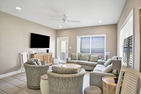 The spacious living room has a TV and private balcony access