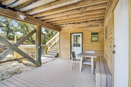 Covered deck and entrance to the downstairs suite