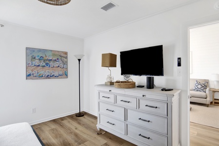 The guest bedroom has a TV and views of the water