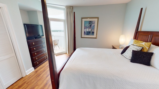 Bedroom 3 has water views, balcony access, a TV and a private bathroom