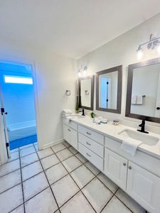 Master bathroom with double vanities and tub/shower combo