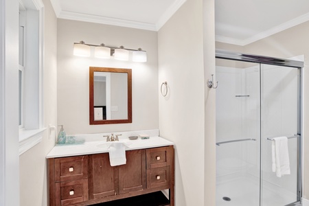 The primary bathroom features a walk in shower