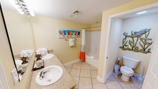 Private bathroom in Bedroom 2 with double sinks, tub/shower combo and private water closet