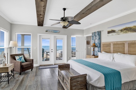The primary bedroom offers a private bathroom, TV and balcony access