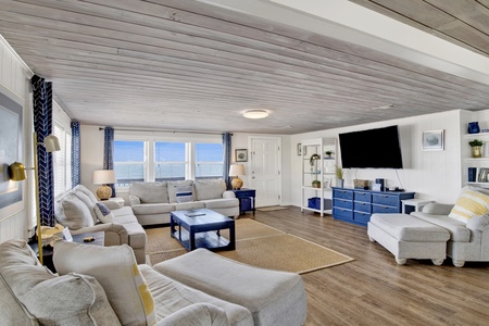 The living room offers plenty of seating and a TV